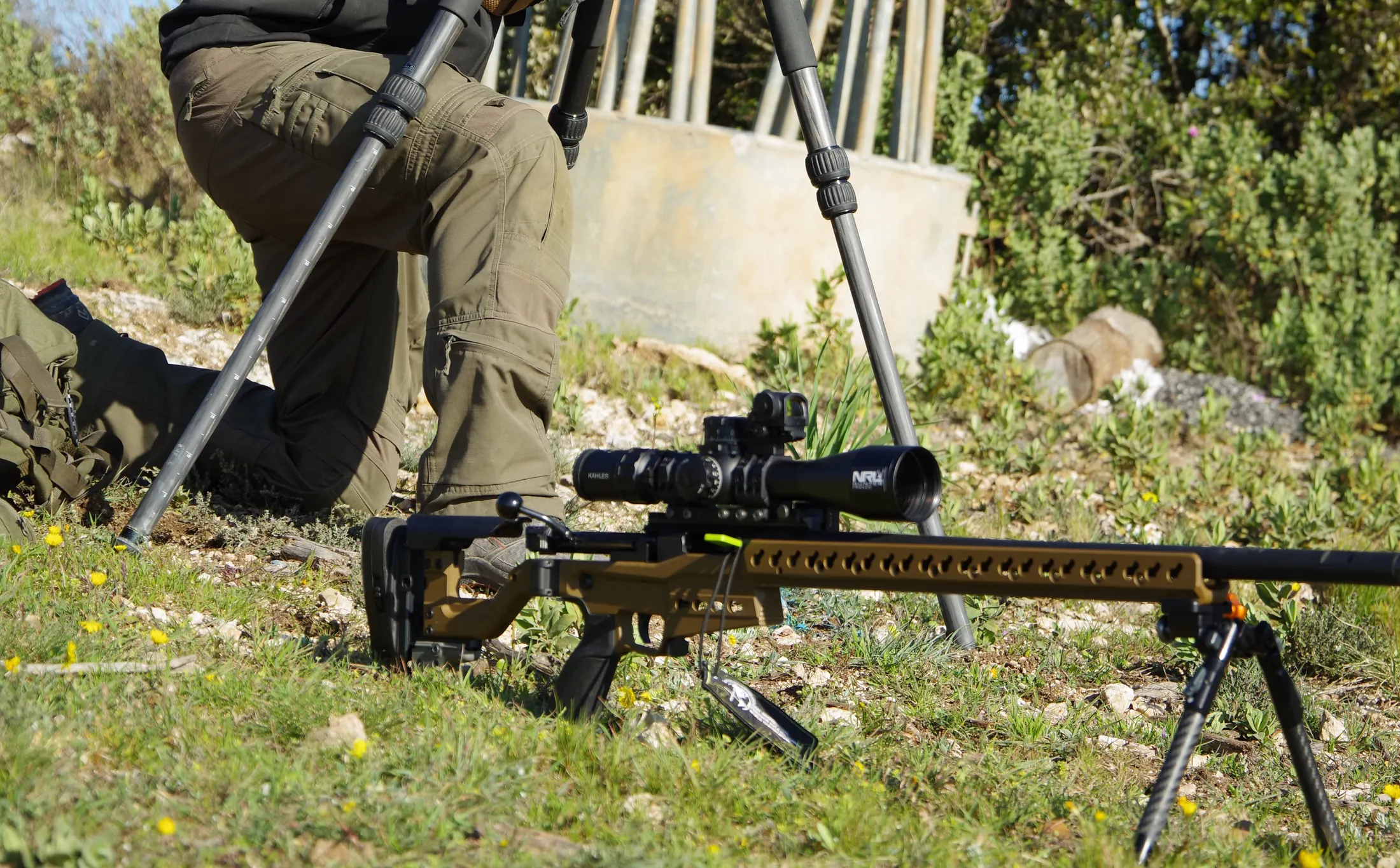Observation aux jumelles sur trépied, fusil posé au sol